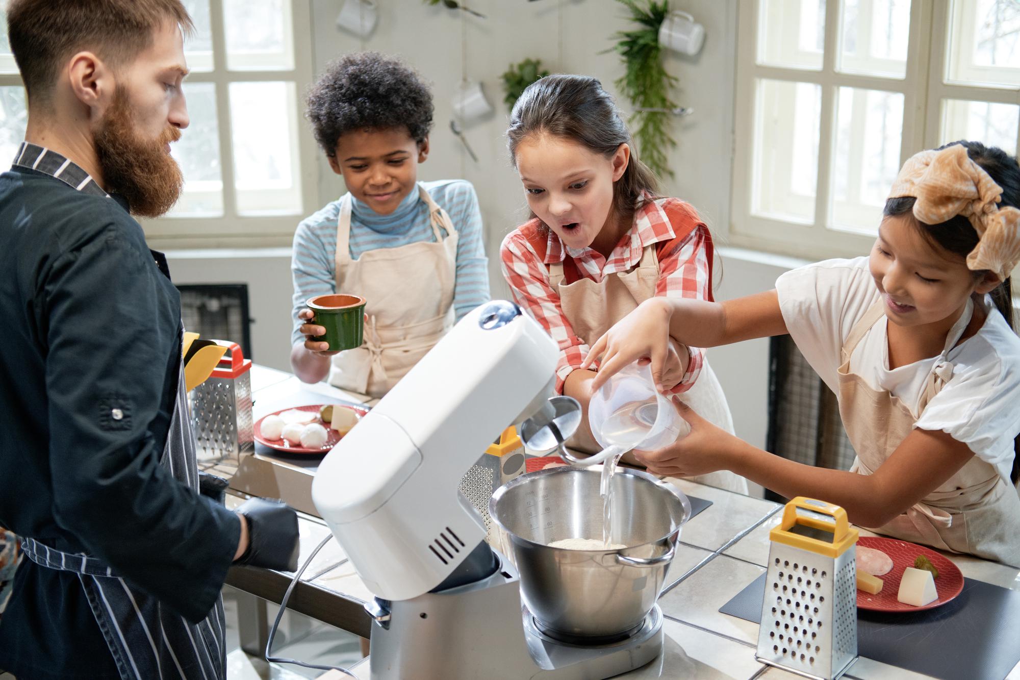 Cozy teaching kitchen with bright utensils and students